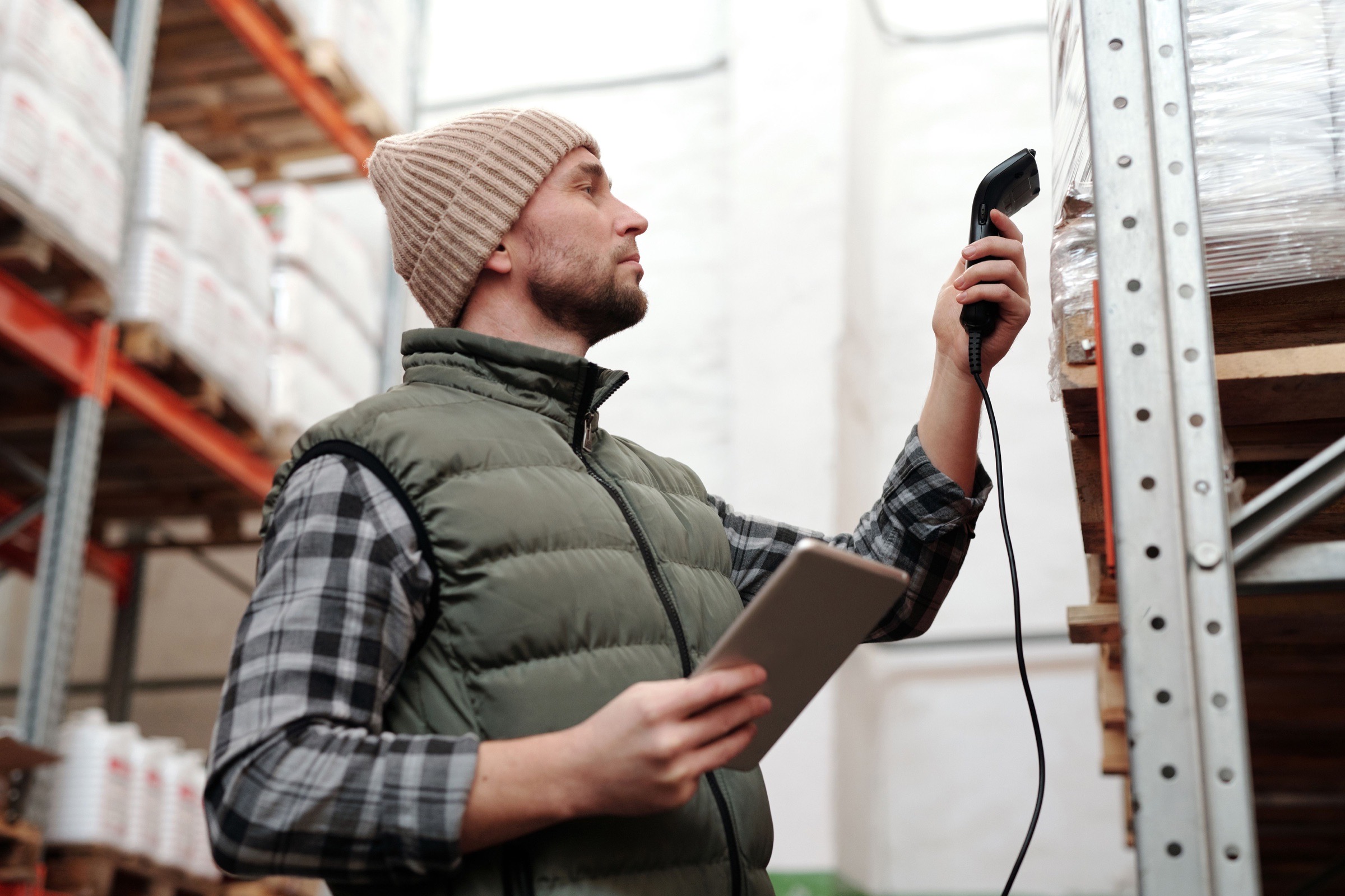 A warehouse operative scanning stock and checking inventory